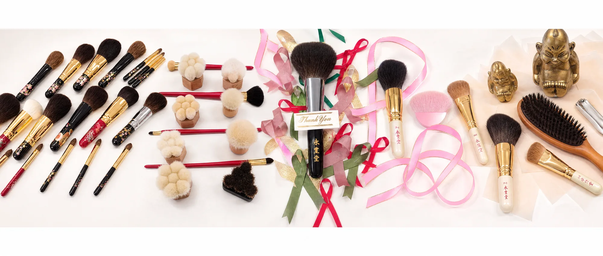 Collection of handcrafted Japanese makeup brushes with lacquered handles and natural bristles